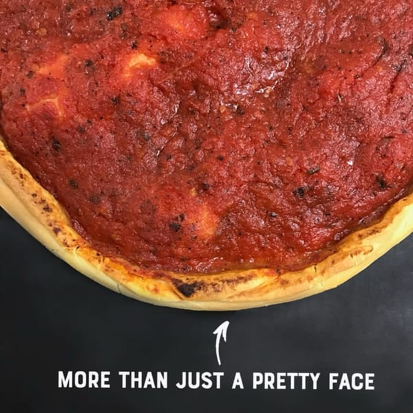 Close-up of a Sicilia's Pizzeria deep-dish pizza with rich red sauce and golden crust.